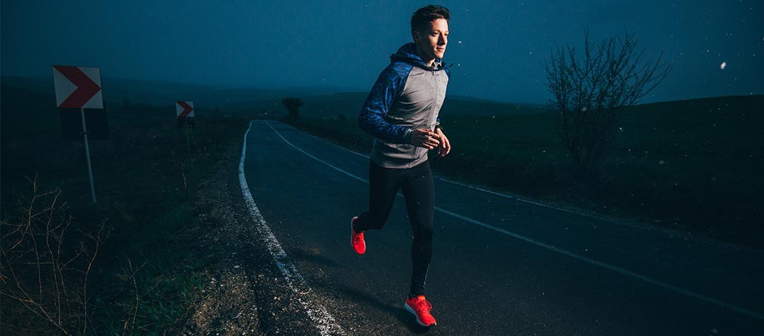 Runner with reflective gear training in low-light conditions—important for safety during early-morning or evening runs in Niantic and East Lyme.